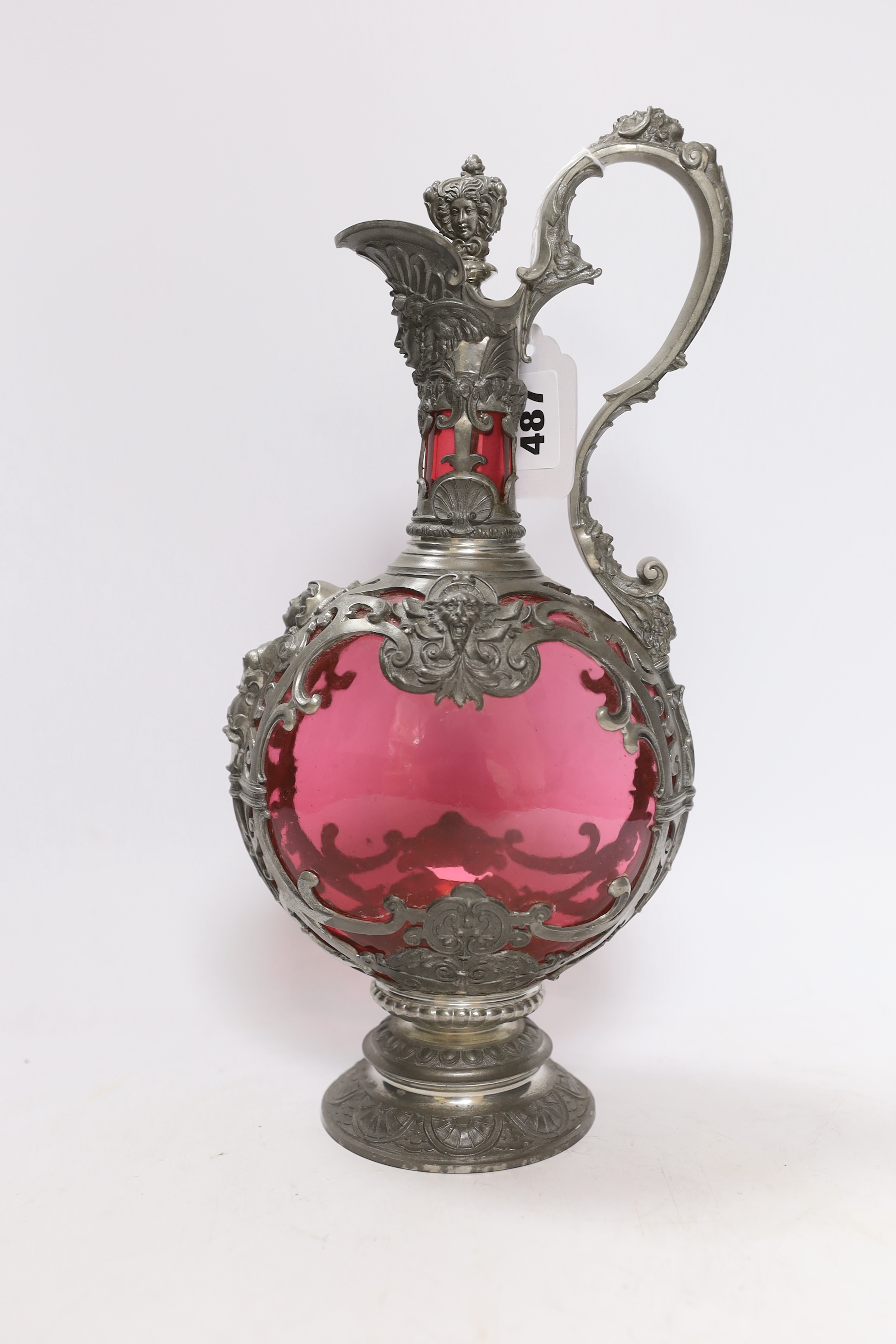 A Bohemian style pewter mounted cranberry glass ewer and twelve glasses, possibly Romanian, 33cm high